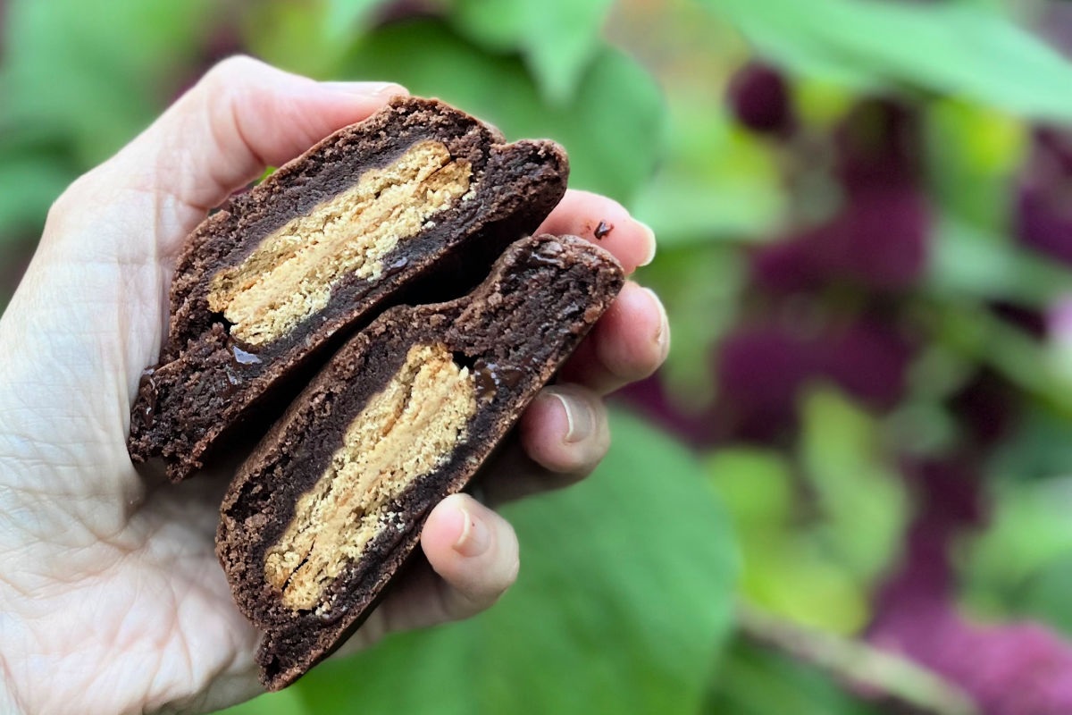 Cross cut double chocolate chip cookies showing a peanut butter crème sandwich cookie in the center.